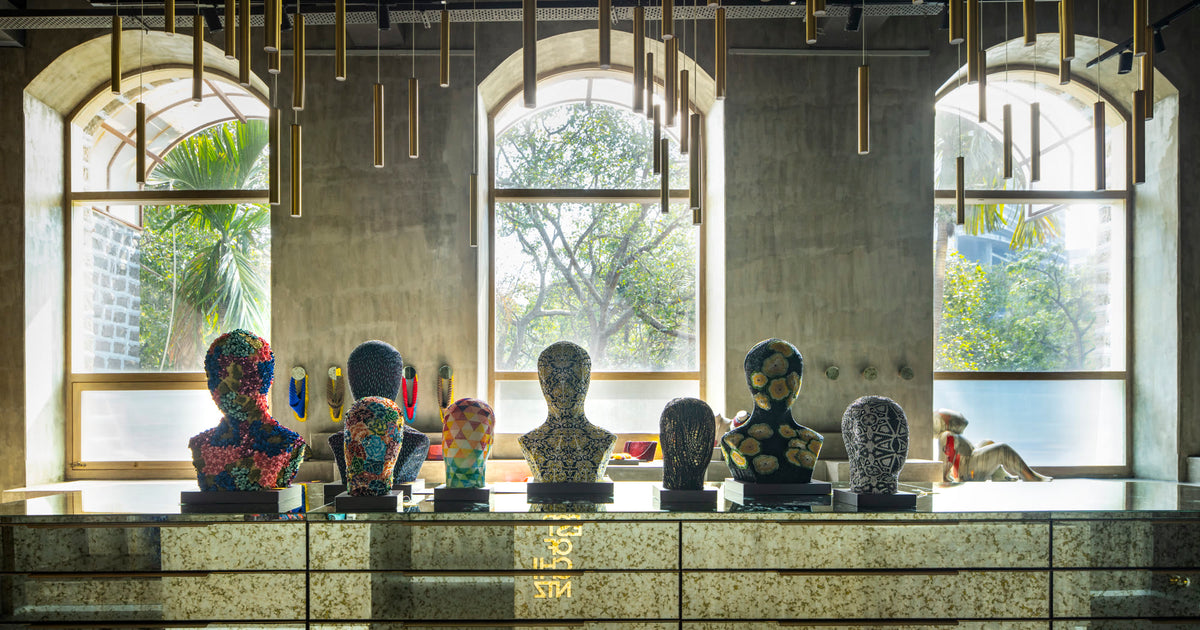 Inside the Forest of Chintz store in Mahalaxmi, Mumbai: hand-embroidered and beaded busts below three arched windows